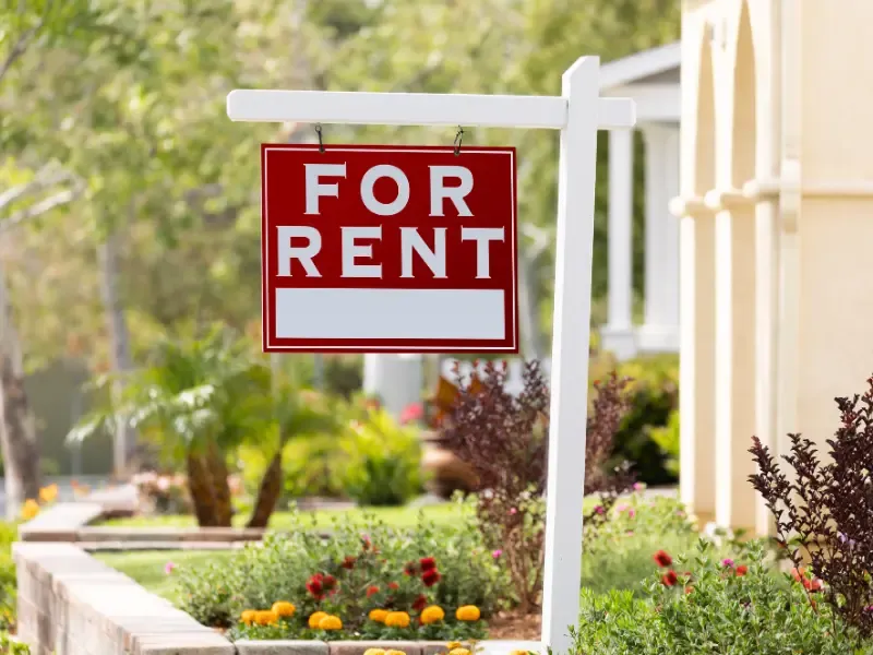 Home with a 'For Rent' sign.