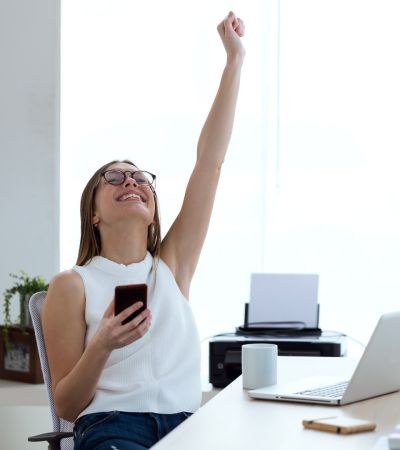 Person cheering at their desk.