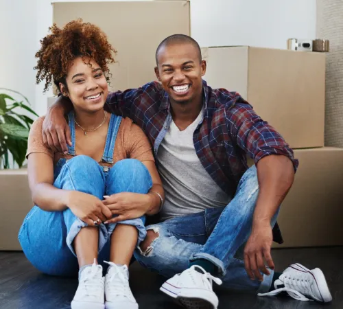 Couple in front of moving boxes.