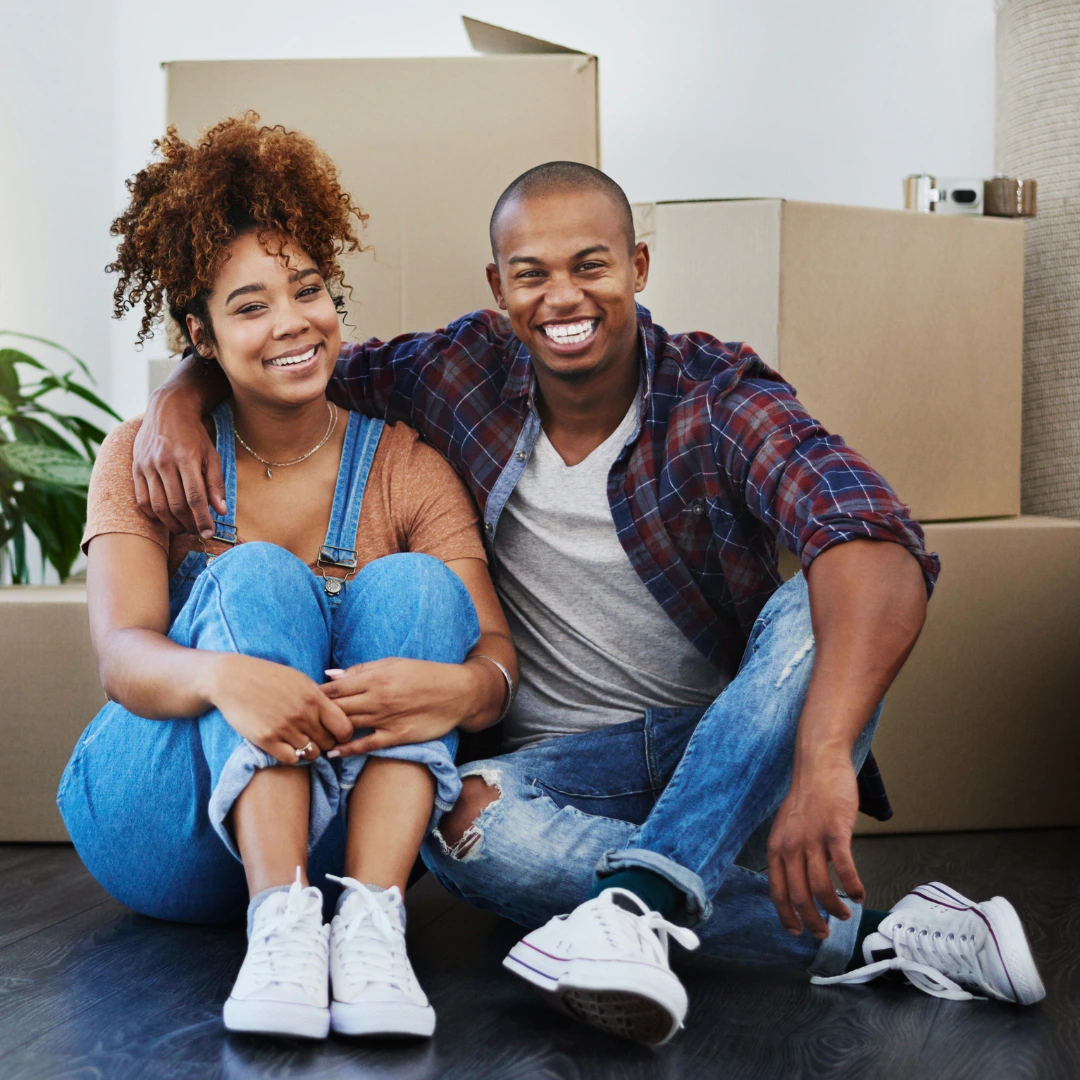 Couple in front of moving boxes.