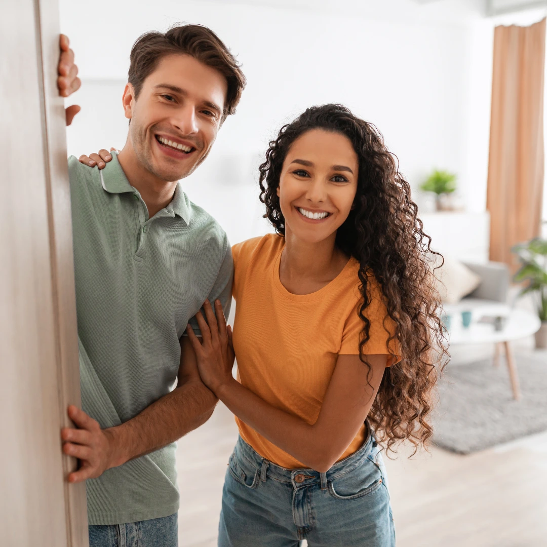 Two people looking out an open door.